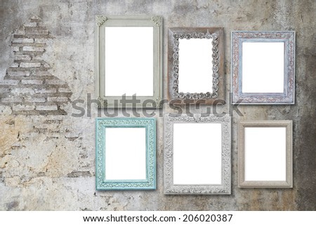 vintage wooden frames on grunge cement wall
