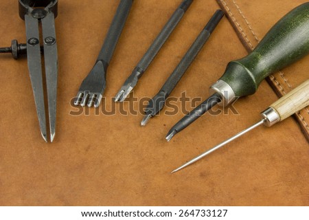 leather craftsman tools on tan leather