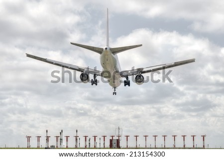 big jet plane landing on airport track