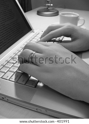 Man\'s hands typing on laptop - black and white
