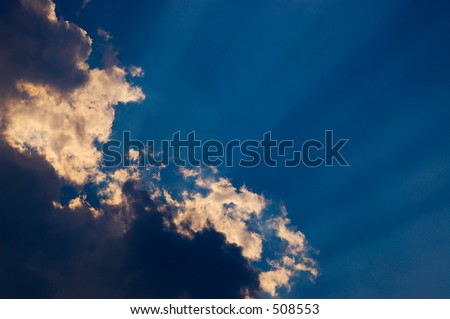 light streaks behind cloud in blue sky