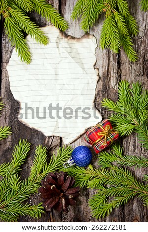 Congratulation to Christmas on  planks background with fir branches