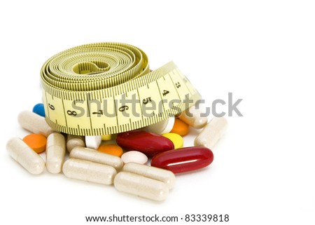 Tape measure and pills, weight loss concept
