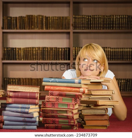 Pensive student laying on books - Square composition