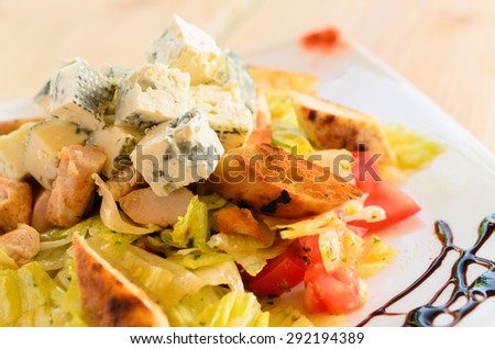 Blue salad with chicken meat, blue cheese, iceberg, lettuce, tomato, bread and dressing