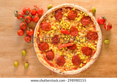 Pizza with salami, corn, ham and pepperoni - Top view