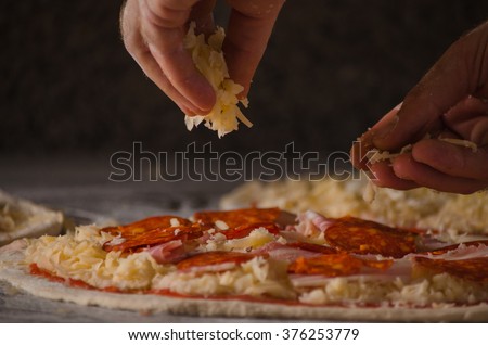 Hands preparing a pizza