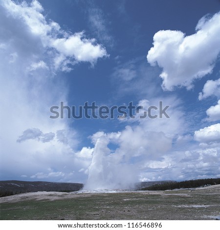 Thermal water spouting out of the hill under the cloudy sky