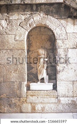 A statue of a symbolic figure with head and right arm missing, Athens