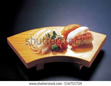 High angle view of sushi rolls and sashimi on a serving board