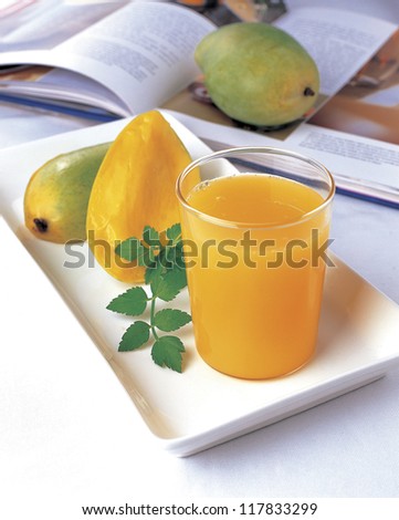 mango juice with a peeled  mango