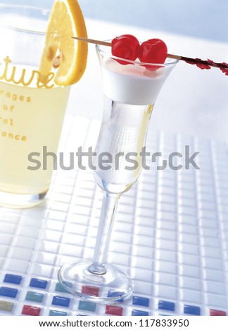 glass with cherries on top
