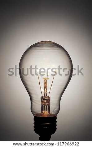 a light bulb lit up in a grey background