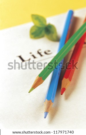 color pencils in different colors stacked on a piece of paper
