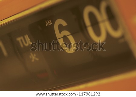 close up shot of a flip clock showing the time and the day
