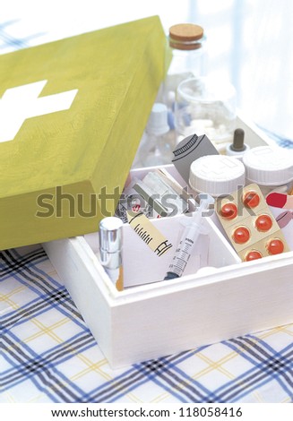 Medical kit with pills and tools on the table