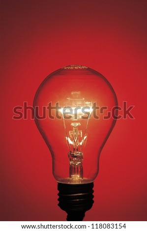 a light bulb lit up in red background
