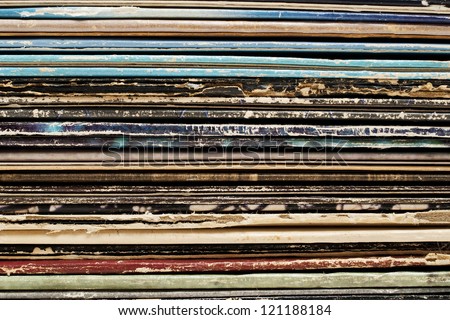 Close up stack of vintage vinyl records in sleeves