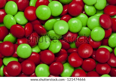 Close up shot of red and green milk chocolate holiday candies, shot from above.