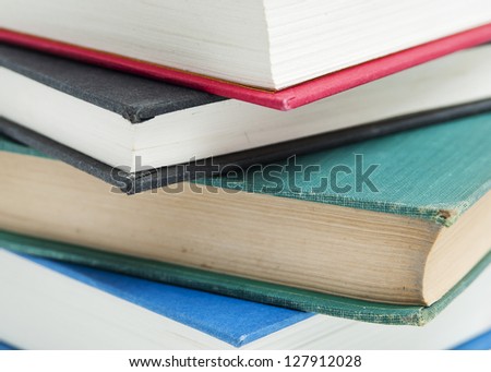 A close up shot of a stack of book isolated on a white background.