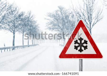 winter driving - winding country road in winter - risk of snow and ice