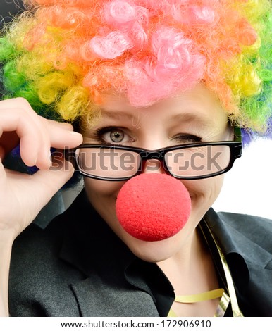 Attractive woman with clown nose and wig winking at the camera