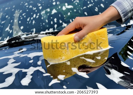 Car Care - Washing a car with a sponge by hand.