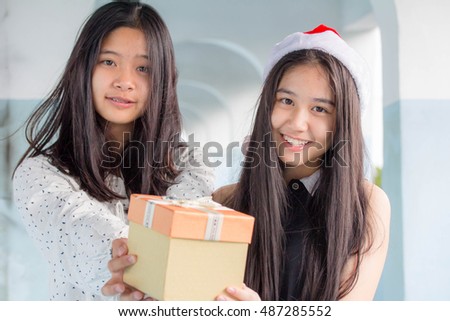two asia thai teen beautiful girl happy new year and Give a Gift Friends