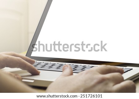 man using a laptop with blank screen