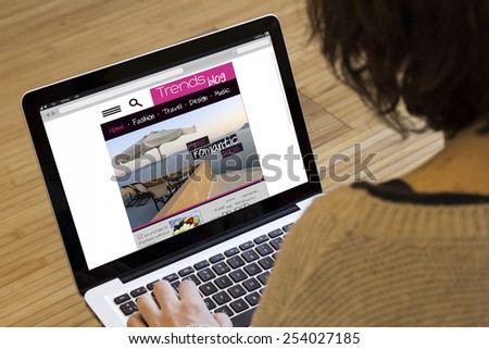 surfing the internet concept: girl visits a trends blog web on a computer