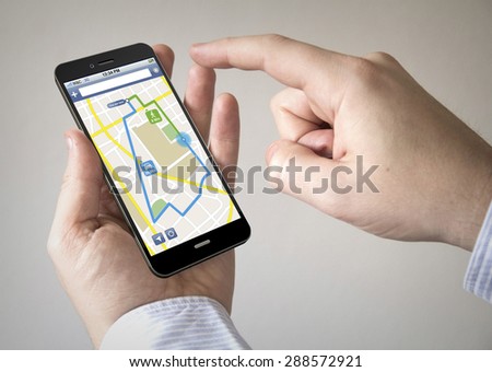 Close up of man using 3g generated mobile smart phone with gps app on the screen. Screen graphics are made up.