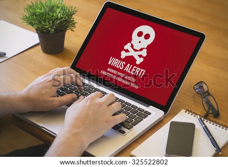 Businessman at work. Close-up top view of man working on laptop virus infected. all screen graphics are made up.