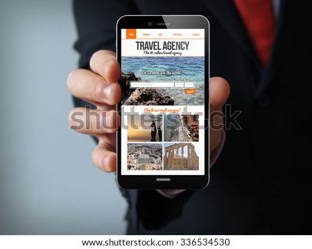 new technologies travel concept: businessman hand holding a 3d generated touch phone with travel agency website on screen. Screen graphics are made up.