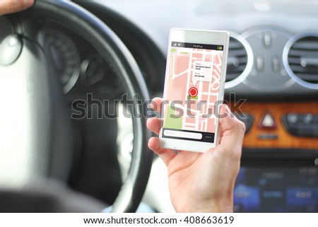 driver holding smartphone with gps map app interface. All screen graphics are made up.