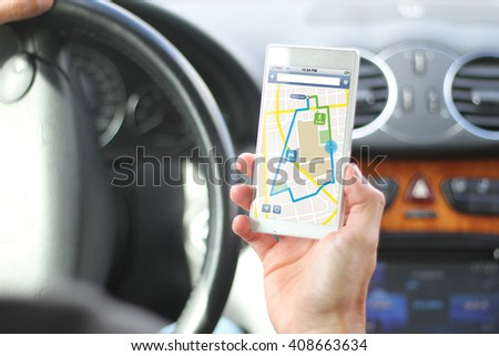 driver holding smartphone with gps app interface. All screen graphics are made up.