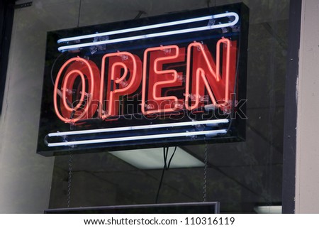 Neon sign informing customers that shop is open for business.