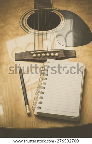 guitar,pencil and scrapbook ,Writing music in film tone