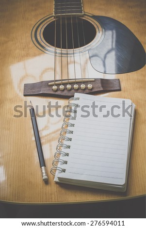 guitar,pencil and scrapbook ,Writing music in film tone