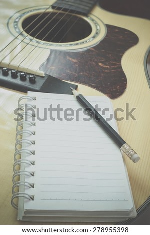 guitar,pencil and scrapbook ,Writing music in vintage tone