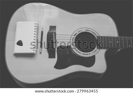 guitar,pencil and scrapbook ,Writing music in black and white tone