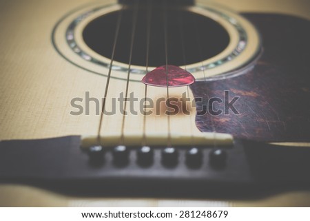 Part of guitar and guitar pick body close up