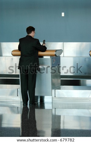 Airline terminal counter with man making cell call