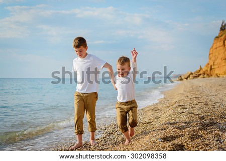 Two brothers playing on the beach