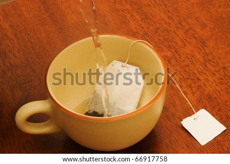 cup of black tea with tag .