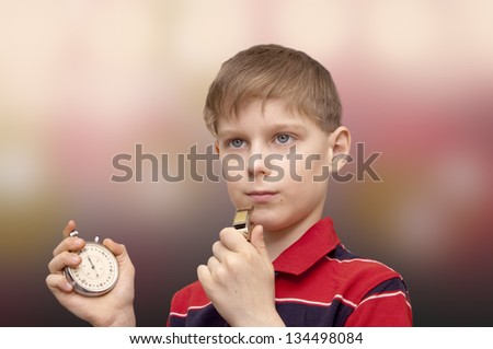 Child - the trainer with a stop watch in a hand trains team