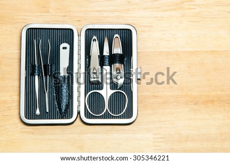 Tools of a manicure set on wooden texture