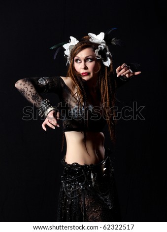 stock photo Attractive bellydancer dancing in tribal makeup and dress