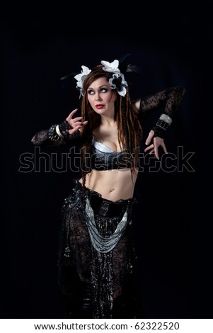 stock photo Attractive bellydancer dancing in tribal makeup and dress
