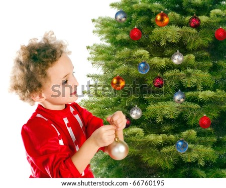 Little girl dresses up a christmas-tree