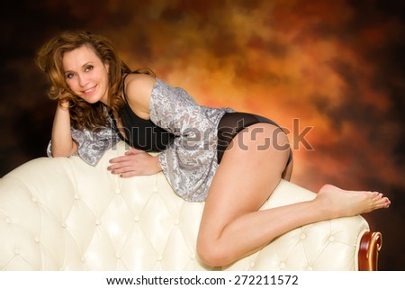 Beautiful adult sexy woman sitting on chair